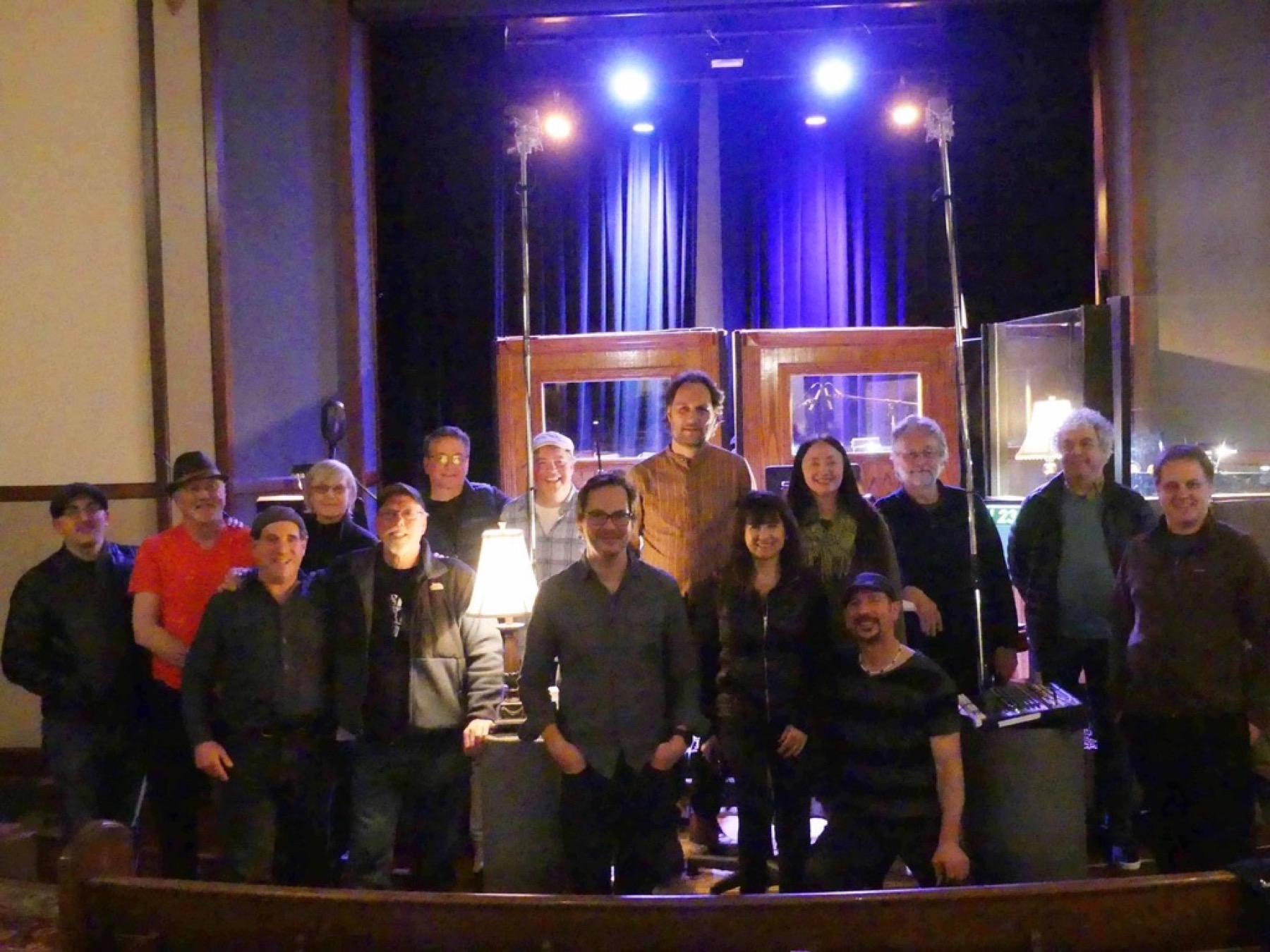 Group photo of musicians standing together on stage